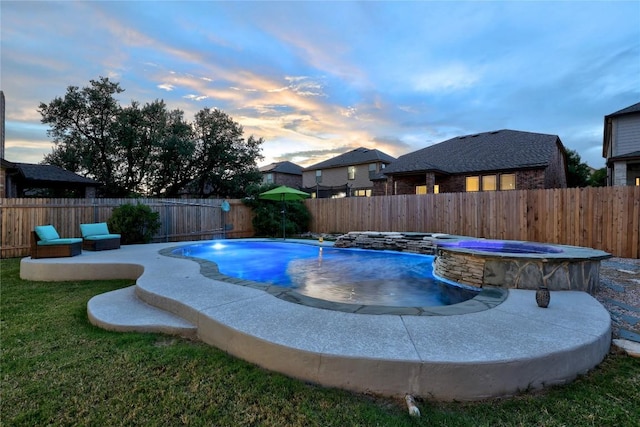 1236 Yellow Iris Rd, Leander, TX 78641 - pool at dusk featuring a fenced backyard and a pool with connected hot tub