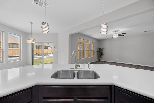 1236 Yellow Iris Rd, Leander, TX 78641 - kitchen featuring light countertops, a ceiling fan, decorative light fixtures, and plenty of natural light