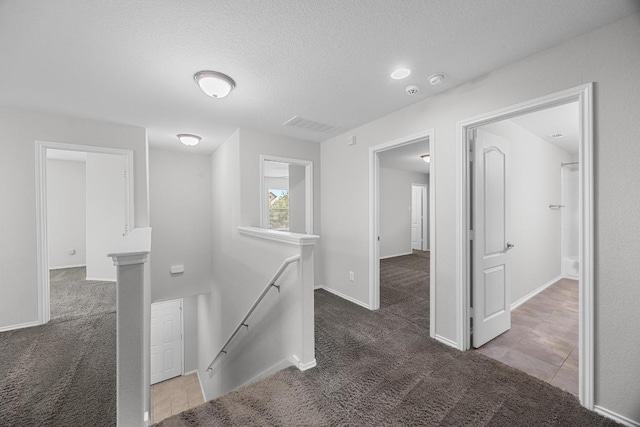 1236 Yellow Iris Rd, Leander, TX 78641 - hallway with an upstairs landing, carpet floors, and a textured ceiling