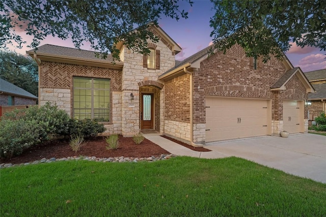 2508 Outlook Ridge Loop, Leander, TX 78641 - view of front of home featuring stone siding, a garage, concrete driveway, and a front lawn