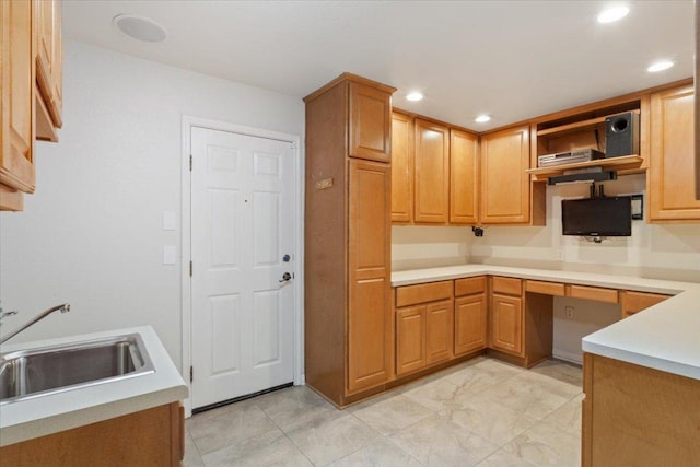 101 Goldenrod Way, Georgetown, TX 78633 - kitchen featuring recessed lighting, open shelves, built in desk, light countertops, and brown cabinetry