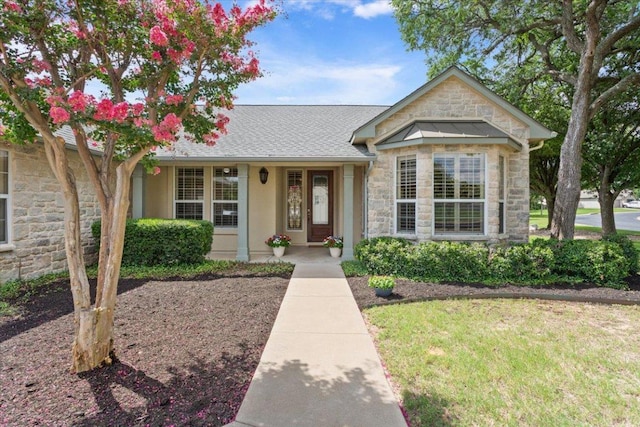 101 Goldenrod Way, Georgetown, TX 78633 - view of front of property with stone siding, a front lawn, and a shingled roof
