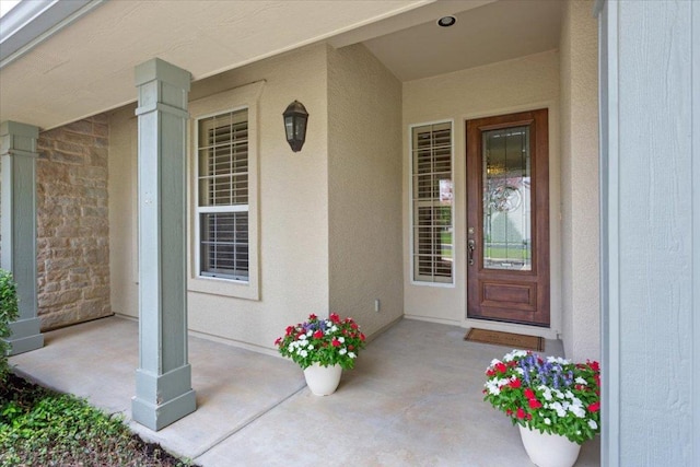 101 Goldenrod Way, Georgetown, TX 78633 - doorway to property featuring a porch and stucco siding