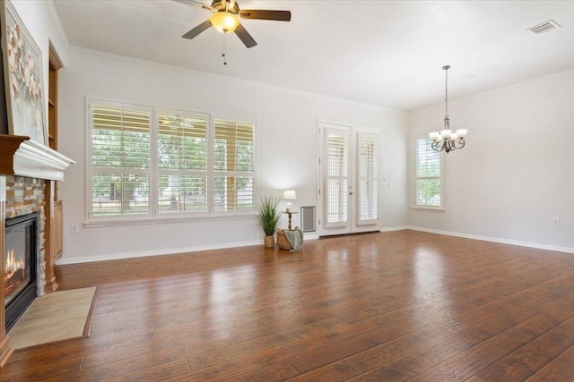 101 Goldenrod Way, Georgetown, TX 78633 - unfurnished living room featuring a fireplace with flush hearth, a chandelier, wood-type flooring, ceiling fan, and crown molding