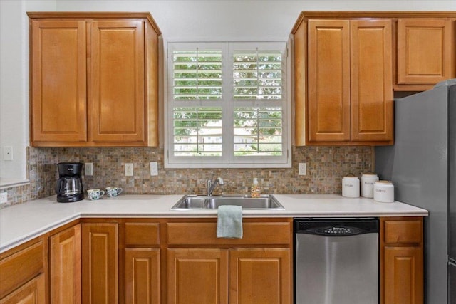 101 Goldenrod Way, Georgetown, TX 78633 - kitchen featuring appliances with stainless steel finishes, decorative backsplash, light countertops, and brown cabinetry