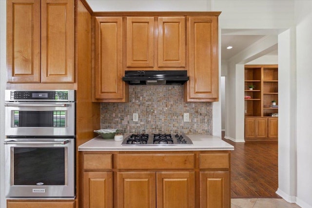 101 Goldenrod Way, Georgetown, TX 78633 - kitchen featuring appliances with stainless steel finishes, under cabinet range hood, backsplash, and light countertops