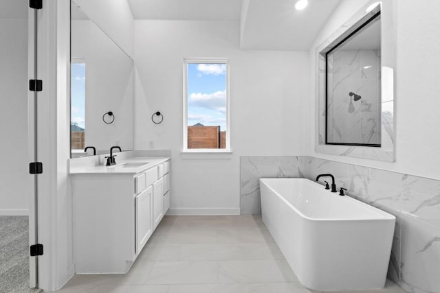 2113 Tobiano Trce, Georgetown, TX 78633 - full bath with a soaking tub, vanity, and marble look tiles
