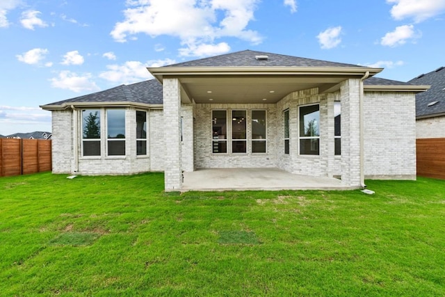2113 Tobiano Trce, Georgetown, TX 78633 - back of property featuring a patio, brick siding, and a fenced backyard