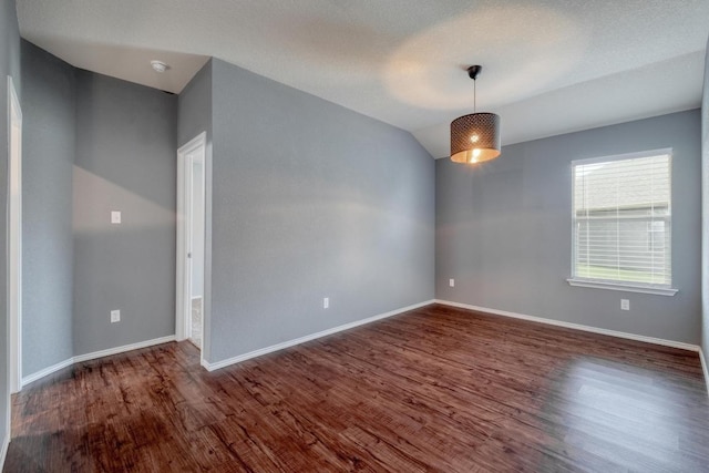 125 Lillian Dr, Taylor, TX 76574 - empty room with wood finished floors, lofted ceiling, and a smoke detector