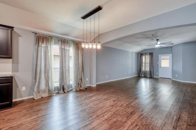 125 Lillian Dr, Taylor, TX 76574 - unfurnished living room featuring a ceiling fan, wood finished floors, and vaulted ceiling