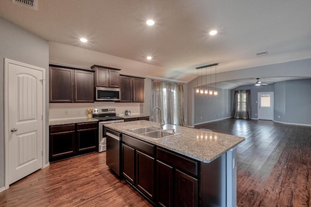 125 Lillian Dr, Taylor, TX 76574 - kitchen featuring appliances with stainless steel finishes, dark wood finished floors, a ceiling fan, dark brown cabinetry, and recessed lighting