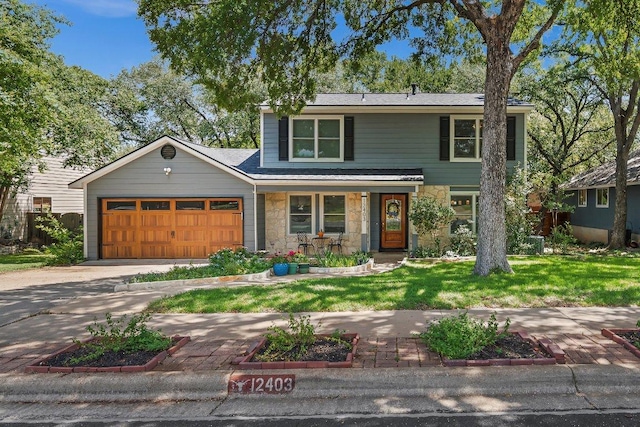 12403 Cassady Dr, Austin, TX 78727 - traditional home with stone siding, an attached garage, a front lawn, and driveway