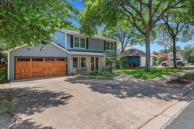 12403 Cassady Dr, Austin, TX 78727 - traditional-style home featuring driveway, stone siding, an attached garage, and a porch