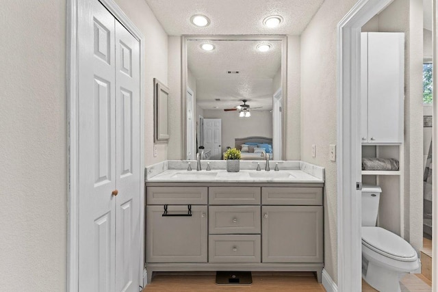 12403 Cassady Dr, Austin, TX 78727 - full bath with a textured ceiling, a closet, double vanity, a textured wall, and a ceiling fan