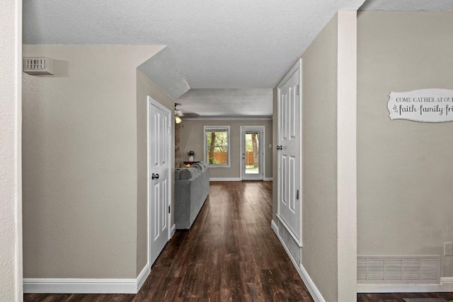 12403 Cassady Dr, Austin, TX 78727 - corridor featuring wood finished floors, a textured ceiling, and a textured wall
