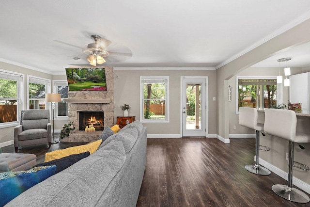 12403 Cassady Dr, Austin, TX 78727 - living room with dark wood-type flooring, a fireplace, a ceiling fan, and ornamental molding