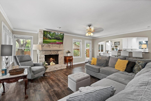 12403 Cassady Dr, Austin, TX 78727 - living area featuring wood finished floors, a ceiling fan, ornamental molding, a fireplace, and arched walkways