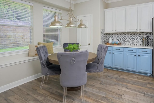 21 Green Terrace Cv, Lakeway, TX 78734 - dining space featuring ornamental molding, light wood finished floors, and plenty of natural light