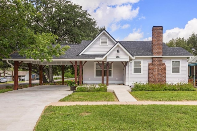 522 S Walnut Ave, Luling, TX 78648 - view of front of home with driveway, a chimney, a front yard, a carport, and a shingled roof