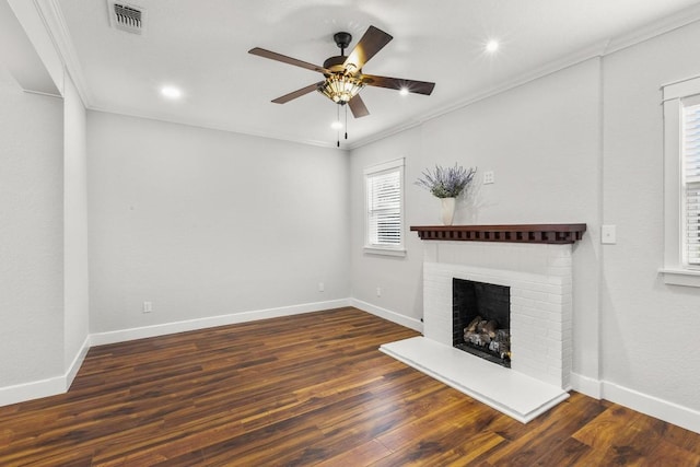 522 S Walnut Ave, Luling, TX 78648 - unfurnished living room with plenty of natural light, ceiling fan, a fireplace, crown molding, and wood finished floors