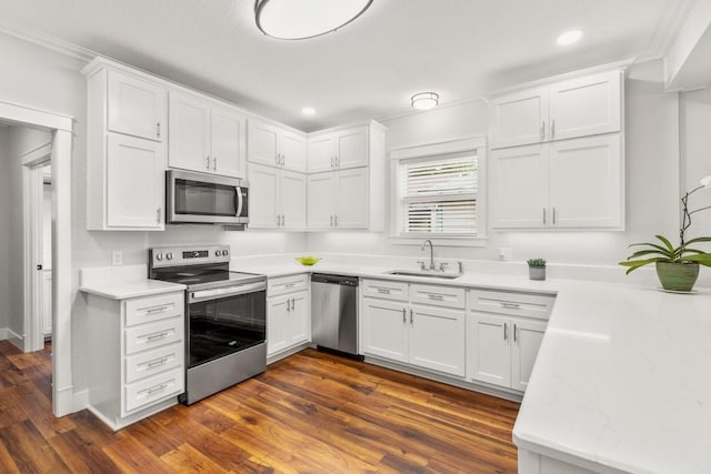 522 S Walnut Ave, Luling, TX 78648 - kitchen with stainless steel appliances, white cabinetry, recessed lighting, dark wood-type flooring, and light stone counters