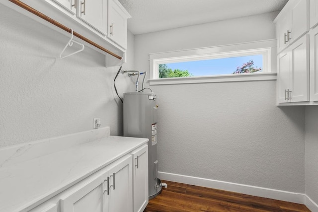 522 S Walnut Ave, Luling, TX 78648 - washroom with water heater and dark wood-style floors