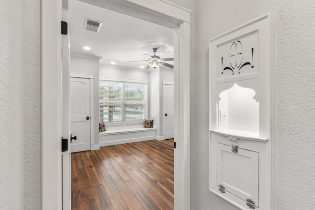 522 S Walnut Ave, Luling, TX 78648 - hall featuring dark wood-style floors, crown molding, a textured wall, and recessed lighting