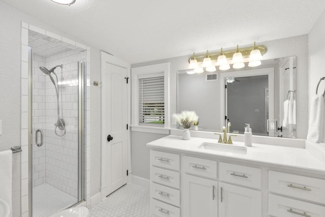 522 S Walnut Ave, Luling, TX 78648 - full bath featuring vanity, a stall shower, tile patterned floors, and a ceiling fan