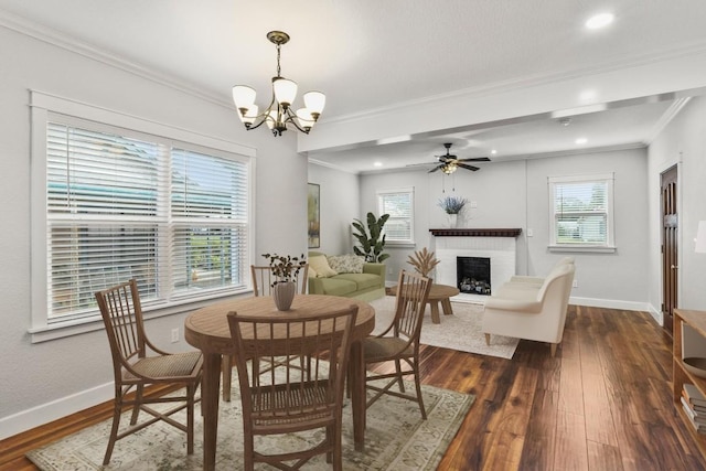 522 S Walnut Ave, Luling, TX 78648 - dining area featuring crown molding, a fireplace with raised hearth, a chandelier, dark wood finished floors, and recessed lighting
