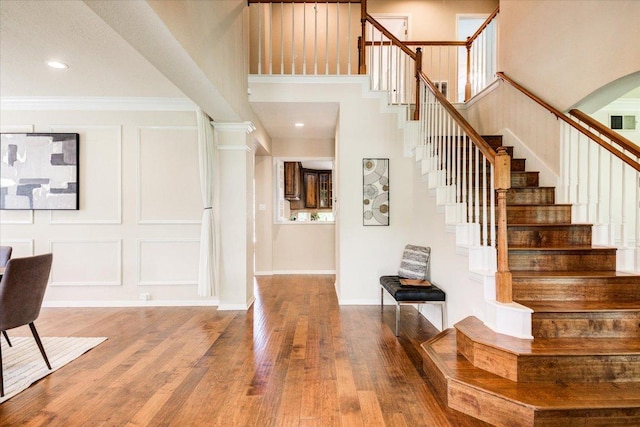 10601 Queensbury Cv, Austin, TX 78726 - foyer entrance with stairs, wood finished floors, crown molding, a decorative wall, and recessed lighting