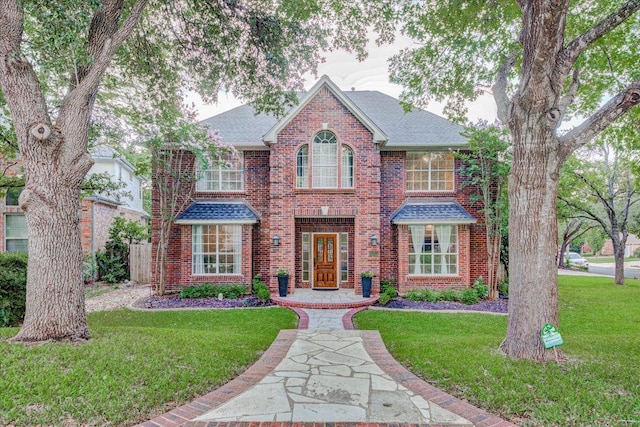10601 Queensbury Cv, Austin, TX 78726 - view of front of home with brick siding, a front yard, and roof with shingles