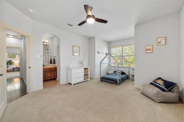 107 Bella Strada Cv, Lakeway, TX 78734 - living area with light carpet, arched walkways, and a ceiling fan