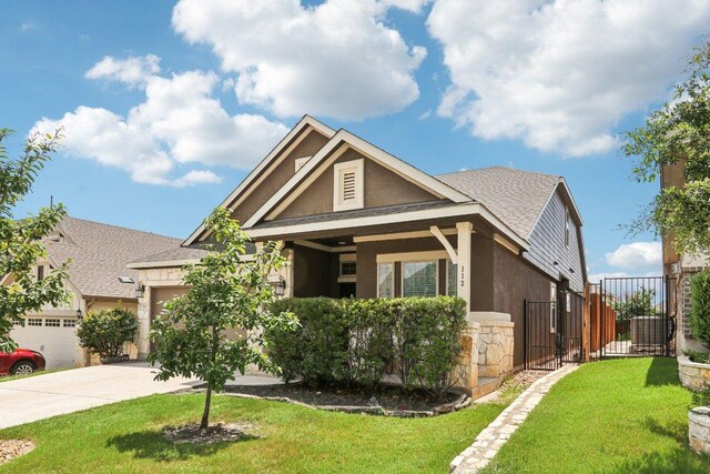 113 Berkeley Pl, Georgetown, TX 78628 - view of front of property with a garage, driveway, stucco siding, and stone siding