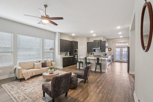 113 Berkeley Pl, Georgetown, TX 78628 - living room featuring dark wood-type flooring, a ceiling fan, recessed lighting, and french doors