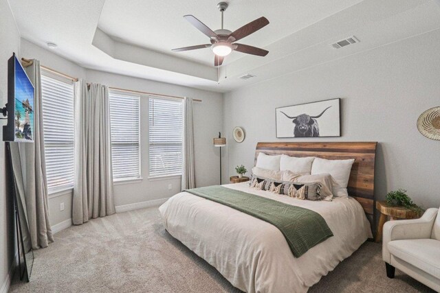 113 Berkeley Pl, Georgetown, TX 78628 - bedroom featuring carpet floors, a tray ceiling, and ceiling fan