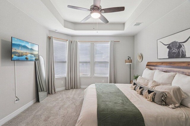 113 Berkeley Pl, Georgetown, TX 78628 - carpeted bedroom featuring a raised ceiling and a ceiling fan