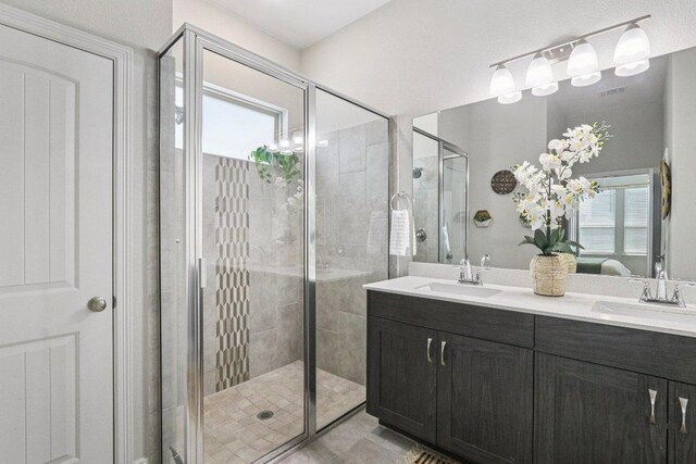 113 Berkeley Pl, Georgetown, TX 78628 - bathroom featuring a stall shower, double vanity, and tile patterned flooring