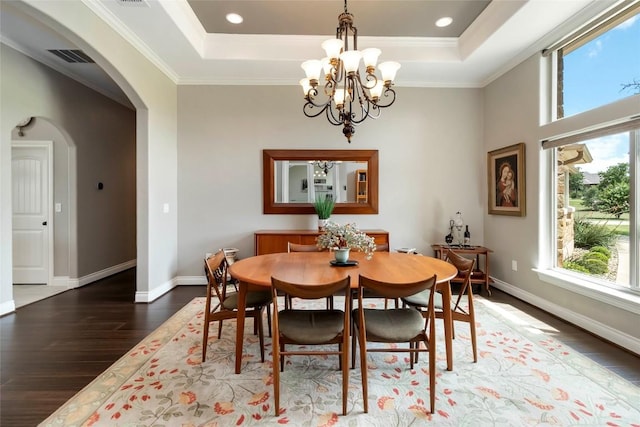 106 Packsaddle Dr, Bastrop, TX 78602 - dining room with a tray ceiling, healthy amount of natural light, wood finished floors, arched walkways, and ornamental molding