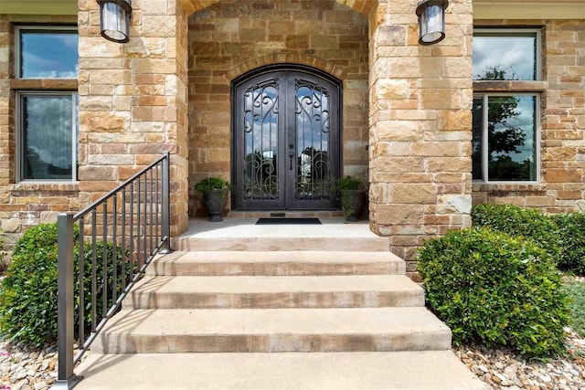 106 Packsaddle Dr, Bastrop, TX 78602 - property entrance with french doors and stone siding