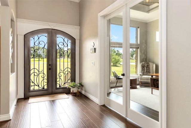 106 Packsaddle Dr, Bastrop, TX 78602 - foyer entrance featuring french doors, healthy amount of natural light, dark wood finished floors, crown molding, and arched walkways