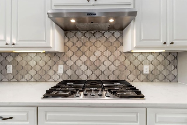 106 Packsaddle Dr, Bastrop, TX 78602 - kitchen view of stainless steel gas cooktop, under cabinet range hood, white cabinets, and tasteful backsplash