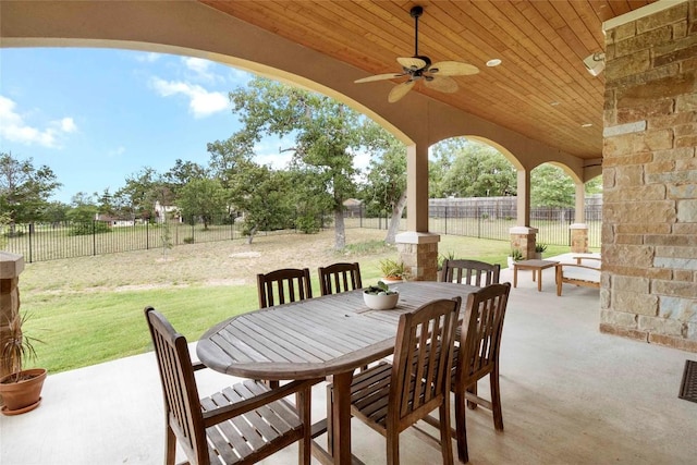 106 Packsaddle Dr, Bastrop, TX 78602 - fenced backyard featuring a patio, ceiling fan, and outdoor dining space
