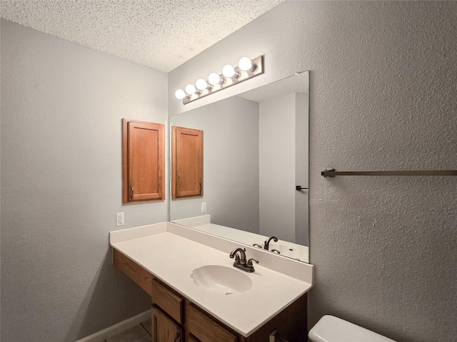 1318 Chalk Ln, Cedar Park, TX 78613 - half bathroom with vanity, a textured ceiling, and a textured wall