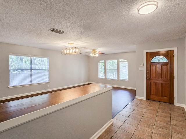 1318 Chalk Ln, Cedar Park, TX 78613 - entrance foyer featuring light tile patterned floors, ceiling fan, and a textured ceiling