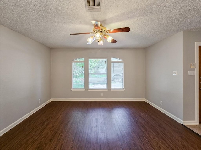 1318 Chalk Ln, Cedar Park, TX 78613 - unfurnished room with a ceiling fan, dark wood finished floors, and a textured ceiling