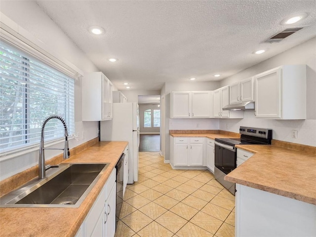 1318 Chalk Ln, Cedar Park, TX 78613 - kitchen featuring stainless steel electric range oven, under cabinet range hood, dishwasher, a textured ceiling, and white cabinets