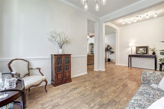 4304 Lost Oasis Holw, Austin, TX 78739 - living area featuring arched walkways, wood finished floors, ornamental molding, and a ceiling fan