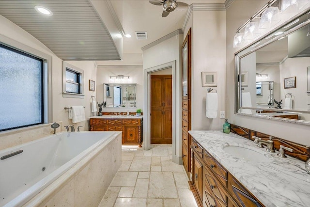 14305 Geronimo St, Leander, TX 78641 - full bath featuring stone tile floors, two vanities, a garden tub, ornamental molding, and a ceiling fan