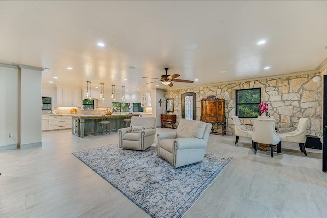 14305 Geronimo St, Leander, TX 78641 - living room featuring a ceiling fan, crown molding, plenty of natural light, and recessed lighting
