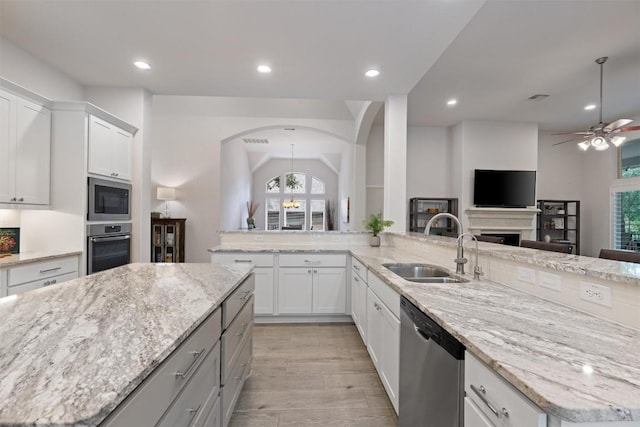624 Judge Fisk Dr, Leander, TX 78641 - kitchen with appliances with stainless steel finishes, a ceiling fan, light stone countertops, recessed lighting, and open floor plan